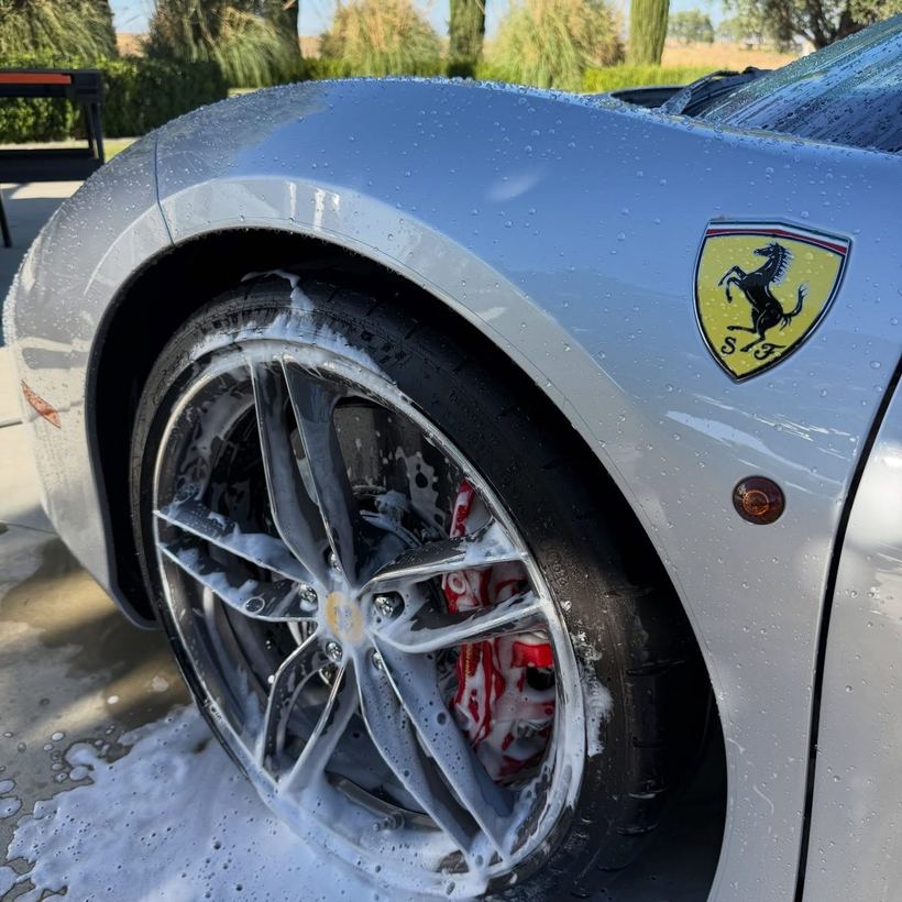 Ferrari wheel covered in foam during a wash
