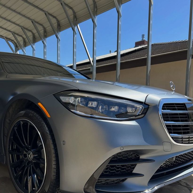 Silver Mercedes-Benz sedan under a carport